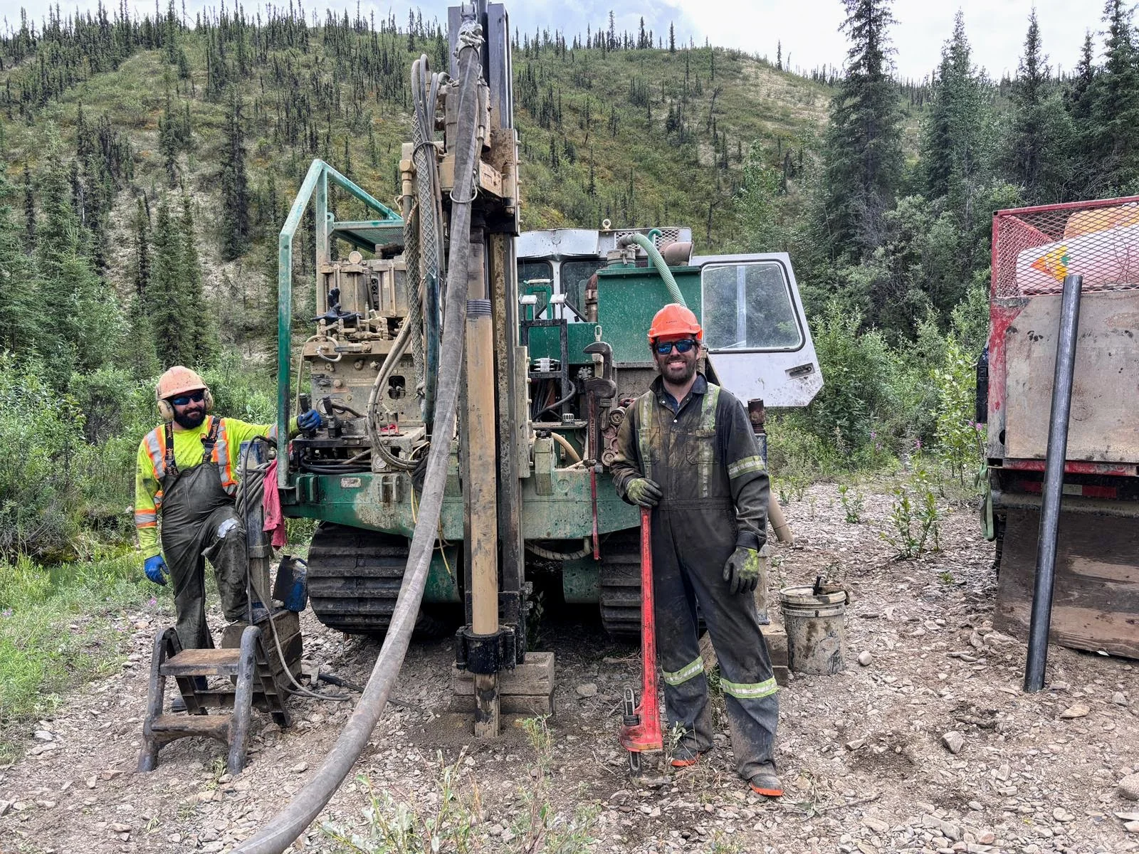 Field crew beside a placer exploration drill